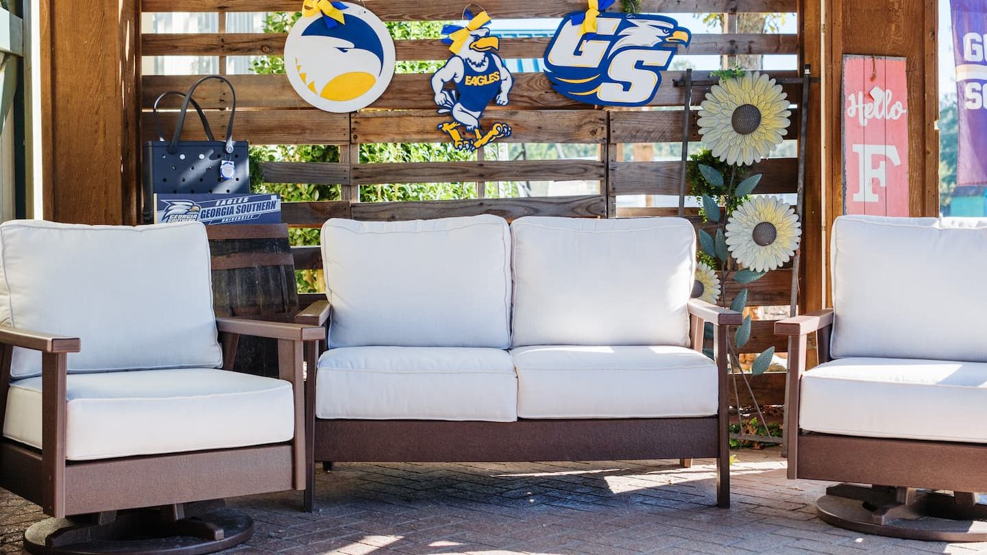 Outdoor patio setup with cushioned furniture, Georgia Southern Eagles decor, and sunflower accents at Anderson’s General Store.