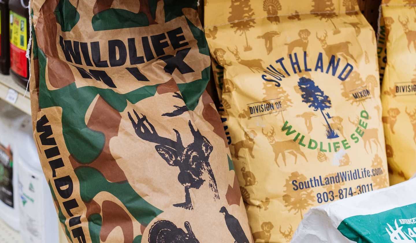 Bags of Davis Feed & Seed Wildlife Mix, Southland Wildlife Seed, and 4S Forage Brassica on display at Anderson’s General Store — quality food plot seed for Georgia deer hunting and wildlife management.