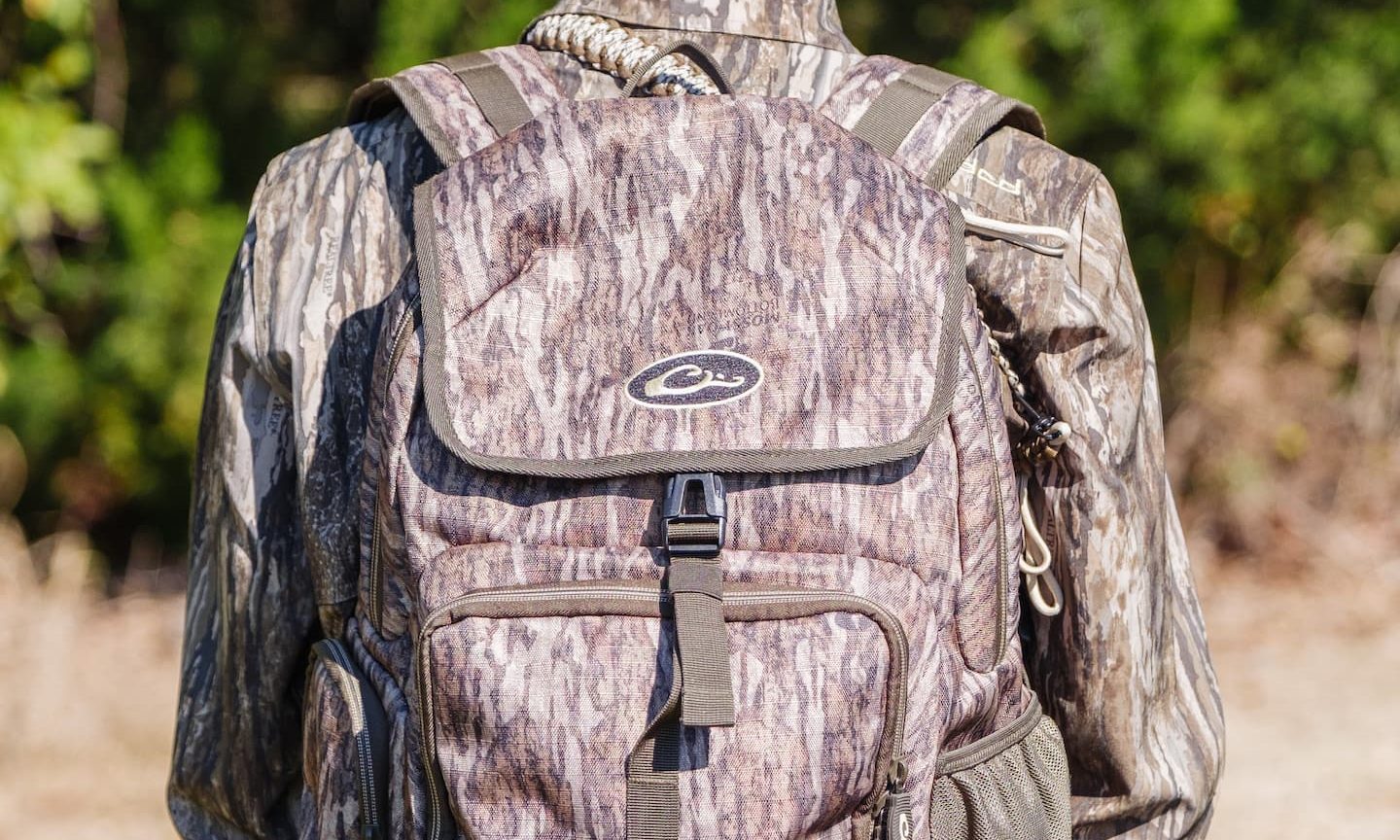 Hunter wearing full camouflage gear and a matching camo backpack from Drake Waterfowl, ready for the hunt in South Georgia’s outdoors.