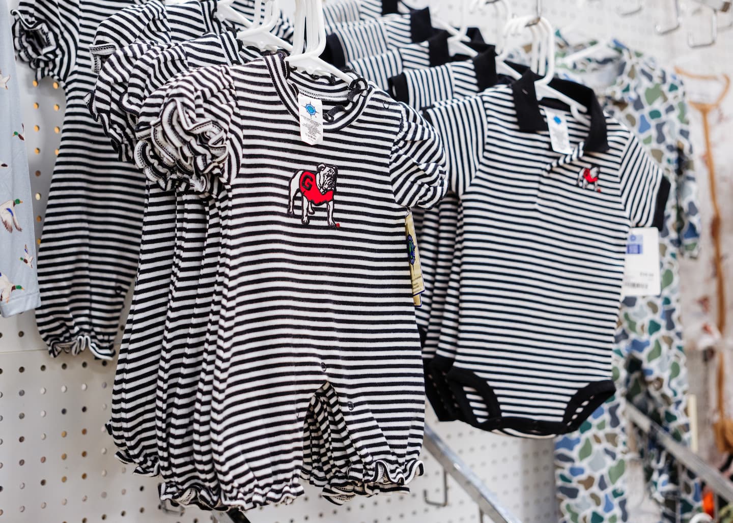 Children's Georgia Bulldogs outfits with black-and-white stripes and embroidered bulldog logos, including rompers and onesie