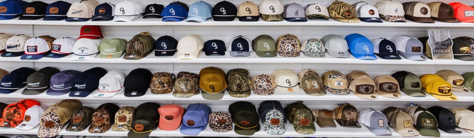 Hat Wall display at Anderson’s General Store featuring a wide variety of leather patch trucker hats, mesh back outdoor hats, and American flag patch hats — including Georgia Southern and hunting styles perfect for Georgia seasons.